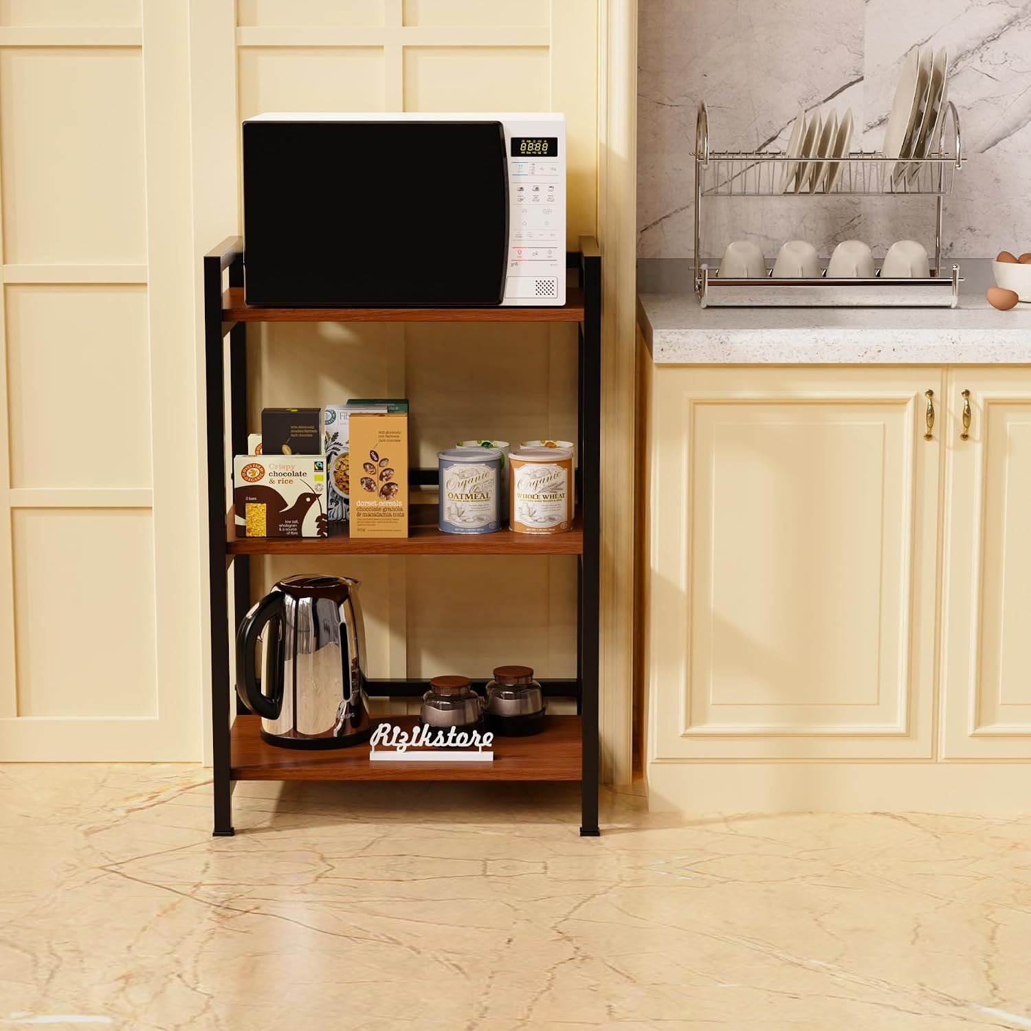ComfyHome 3-tier kitchen storage rack holding a microwave, food containers and a kettle beside a countertop